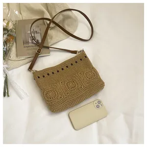Close-up of Bohemian woven shoulder bag featuring floral crochet patterns and wooden beads