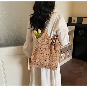 Dettaglio borsa tote boho all'uncinetto con motivi mandala, nappe e perline in legno
