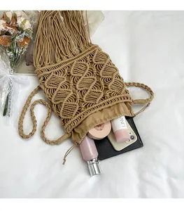 Macro view of bohemian woven bucket bag with long tassels and drawstring lining