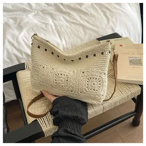 Detail of hand-crocheted beige shoulder bag with brown beads and leather strap texture