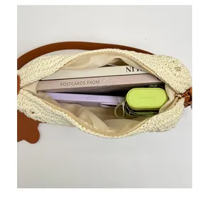 Spacious interior of woven shoulder bag showing capacity for books and accessories
