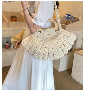 Detail of fan-shaped woven cotton bag with wooden handle and intricate crochet texture
