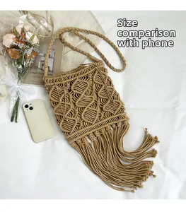 Detail of khaki macrame crossbody bag with long tassels and phone for size comparison