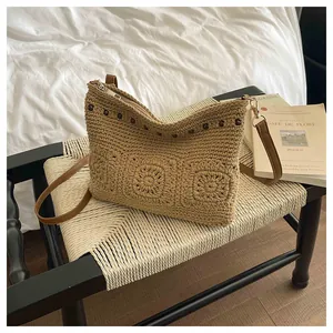 Detail of bohemian hand-woven crossbody bag with 3D floral accents and wooden beads