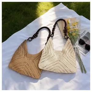Detail of hollow-out crochet bags with vintage wooden bead straps for beach vacation