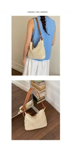 Detail of beige crochet woven hobo bag with adjustable brown leather shoulder strap