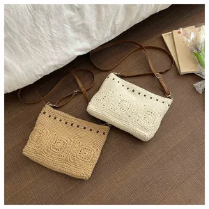 Detailed close-up of woven shoulder bags with floral textures and faux leather straps