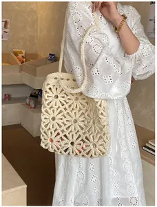 Detail of off-white hollow flower crochet shoulder bag with large capacity for beach travel