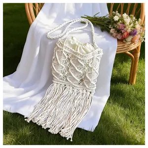 Detail of bohemian macramé bag showing cotton woven patterns and long fringe tassels