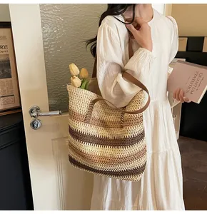 Detail showing high-capacity woven beach tote bag with brown leather straps and striped texture