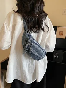 Casual denim chest bag in washed blue with triple zipper pockets and rope knot pullers