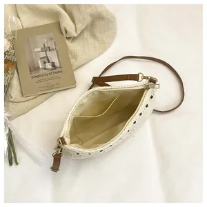 Detail of cream knit bag with black polka dots, brown strap, and inner storage pocket