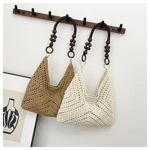 Detailed close-up of handmade hollow crochet knit bags with decorative wooden beads handles