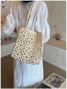 Close-up of beige crochet shoulder bag featuring large hollow daisy floral patterns