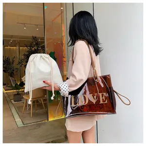 Chic brown transparent PVC tote bag with gold LOVE print and white canvas drawstring liner