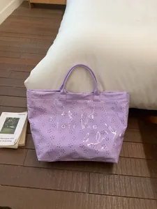 Waterproof lavender hollow tote bag with floral patterns and TOTE BAG lettering