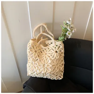 Close-up of handmade hollow floral crochet bag with daisy patterns and soft inner lining