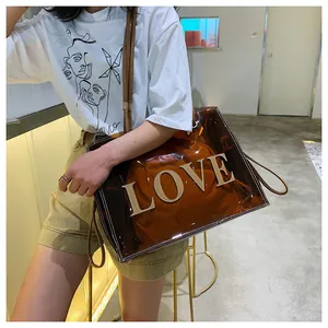 Detail showing the brown transparent PVC tote bag with stylish large 3D LOVE lettering design