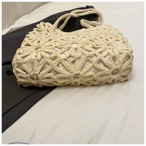 Detail showing the intricate hollow-out floral crochet pattern on this cream woven tote bag