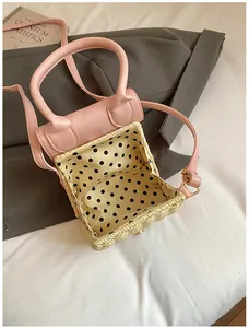 Detail of straw woven bag with pink leather trim and stylish polka dot lining detail