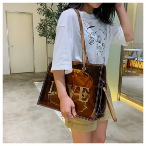 Detail view of transparent caramel tote bag with LOVE embroidery and drawstring inner pouch