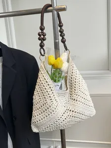 Hollow crochet beach tote with dark brown wooden bead handles and tulip decoration