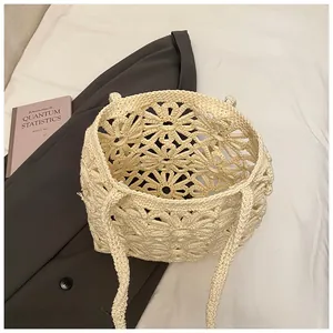 Detail of hollow-out daisy crochet knit tote bag with woven handles for summer beach