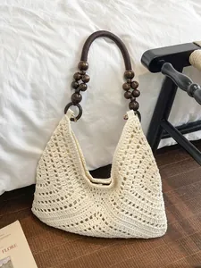 Hollow woven beach tote with wooden bead straps and bohemian geometric pattern