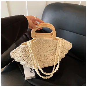 Detail of cream woven cotton bag with a smooth natural wooden circular handle for women