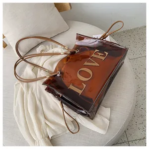 Detail of brown transparent PVC tote with LOVE stitching and inner storage bag