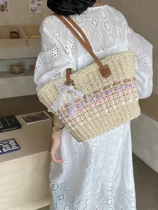 Handwoven straw tote bag with wavy patterns and leather handles for beach vacation