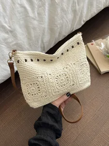 Bohemian off-white hand-woven shoulder bag with floral pattern and dark brown strap