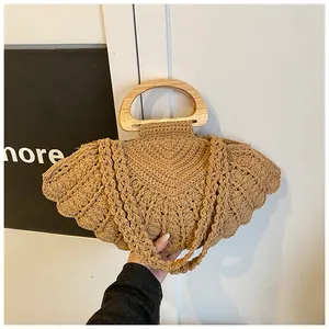 Detail of hand-woven shell pattern tote bag with wooden D-handles and woven straps