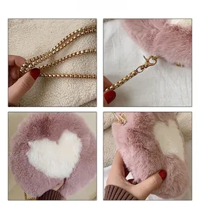 Detail view of pink plush round crossbody bag with white heart and gold chain strap