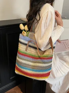 Rainbow striped woven straw beach tote bag with brown leather handles for summer vacation