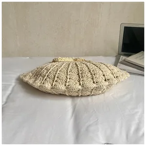 Detailed close-up of handmade woven shell bag with thick cotton thread texture