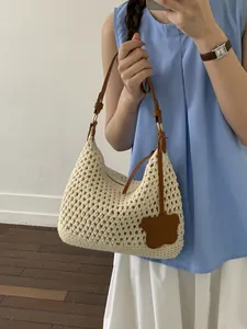 Handwoven cream hobo bag with brown leather strap and bear charm for beach outings