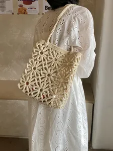 Chic cream floral crochet tote bag with openwork daisy pattern for beach vacations