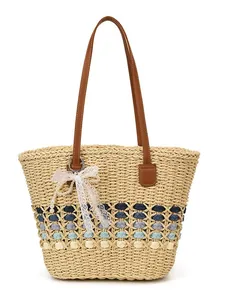 Large straw tote bag with blue hollow weave, brown leather straps, and lace pearl charm