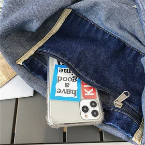 Large denim patchwork crossbody bag showing a pocket with SBS zipper and phone storage