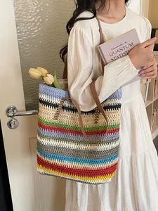 Rainbow striped woven tote bag with brown leather straps for a bohemian beach vacation style