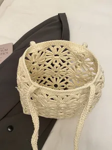 Beige hollow crochet flower tote bag with woven shoulder straps for beach and vacation
