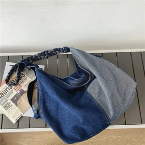 Large denim patchwork tote bag with woven straps and zip closure for casual wear