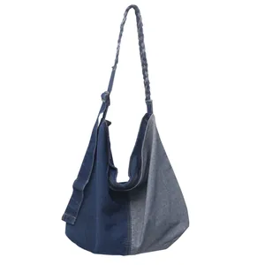 Hobo style denim shoulder bag with contrast splicing and braided adjustable strap