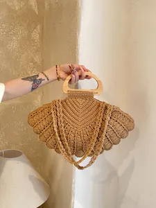 Handwoven khaki shell bag with round wooden handles in a bohemian style for women