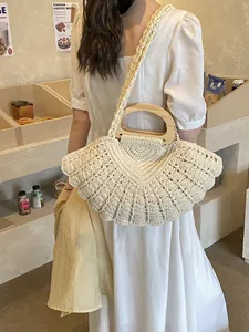 Handwoven shell-shaped cotton bag with wooden handle and matching shoulder strap