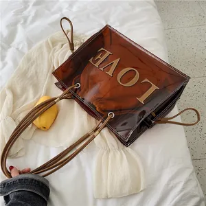 Transparent brown PVC tote bag with LOVE patch and red drawstring inner pouch