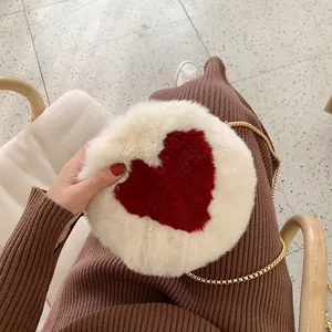 Plush heart-shaped round crossbody bag with gold chain strap for winter fashion
