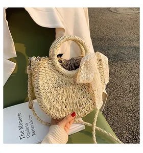 Detailed close-up of straw woven crossbody bag with polka dot drawstring and lace scarf