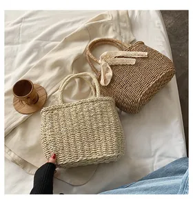 Detailed close-up of woven straw bags featuring decorative lace bows and textures